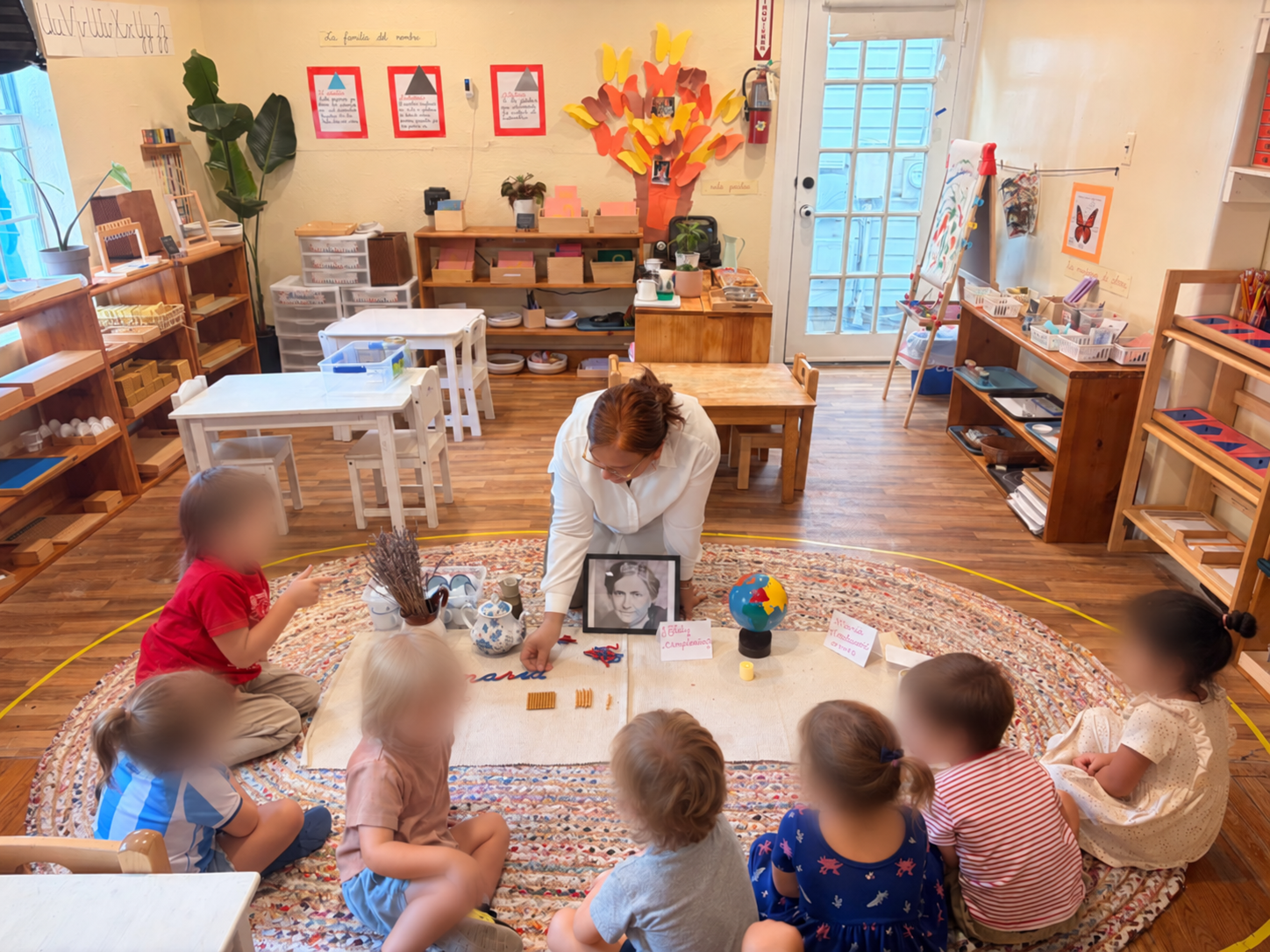 Children and a teacher gathered for a classroom group lesson.
